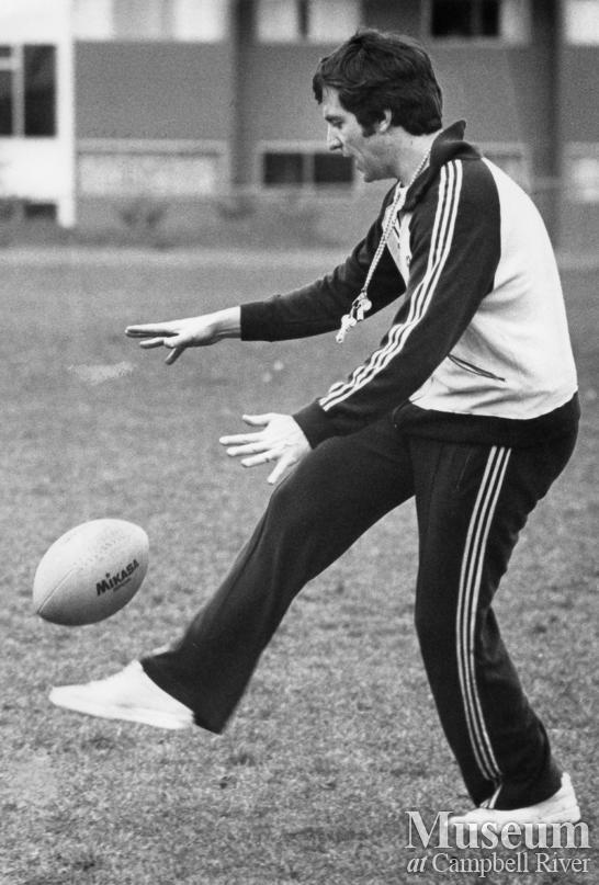C.R. Junior High rugby coach Bruce Izard demonstrates kicking