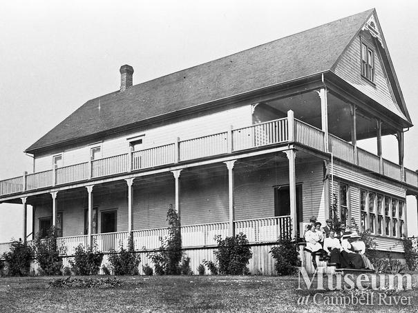 Thulin Family sitting on the front steps of their  home 