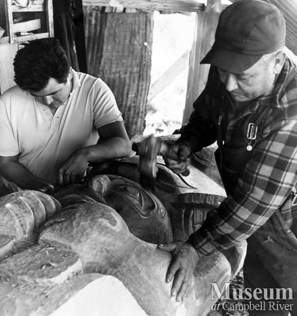 Ernie and Sam Henderson carving the Mileage Totem