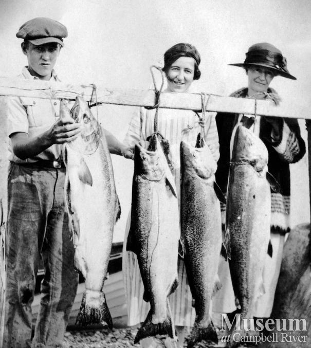 Reginald Pidcock with two women and fish