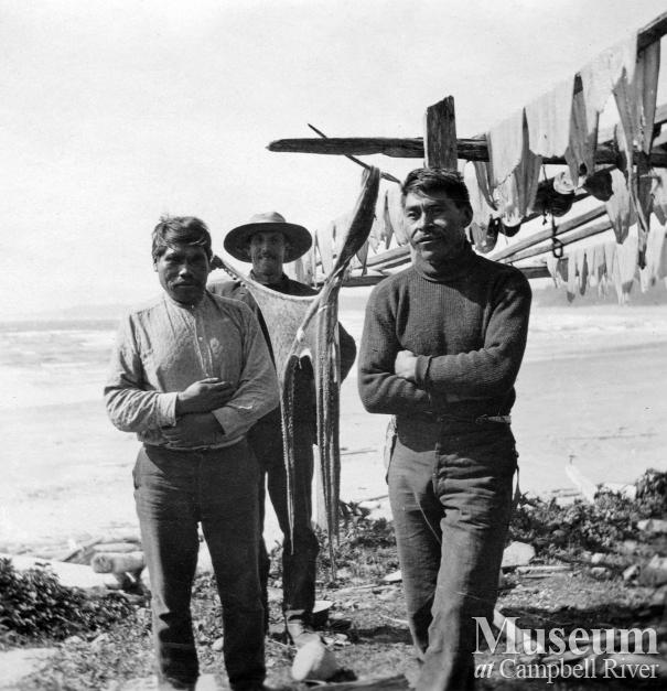 Men drying fish on the waterfront