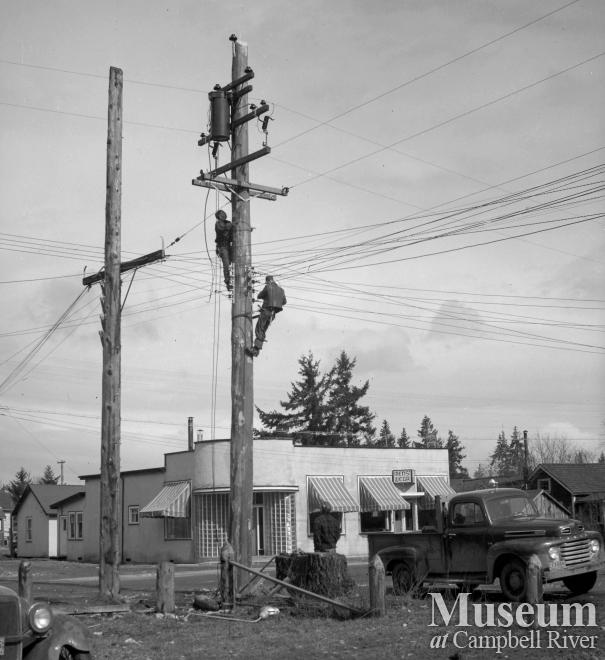BC Hydro employees working on pole in Campbellton